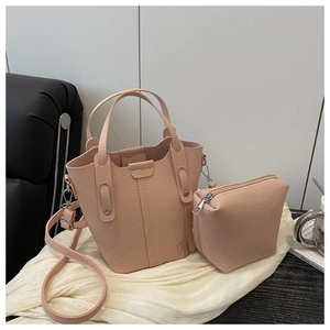 Close-up of litchi textured leather on nude pink bucket bag and zip pouch set