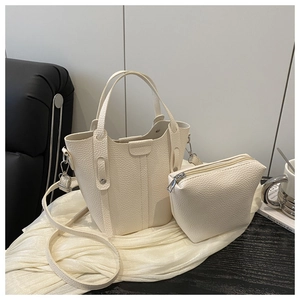 Close-up of cream lychee texture leather bucket bag and matching coin purse set