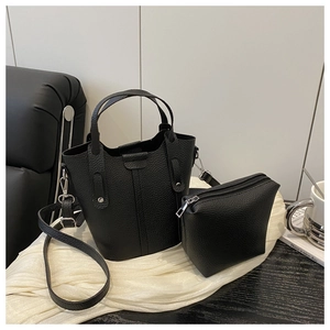 Detail of black litchi grain leather bucket bag set with matching zipper pouch and strap