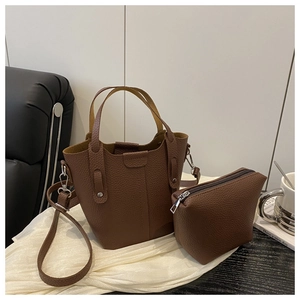 Detailed close-up of brown litchi pattern leather bucket bag set with inner pouch