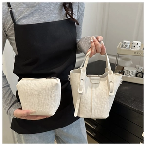 Detailed view of white lychee leather bucket bag set with matching zipper pouch