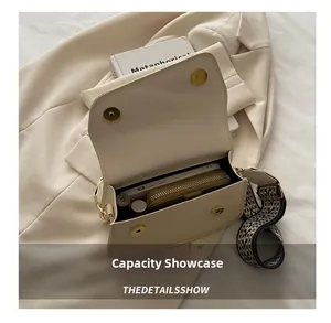Interior view of beige crossbody bag with wide strap showing capacity for phone and wallet