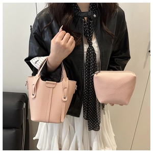 Detail of pink lychee grain leather bucket bag with matching small organizer pouch