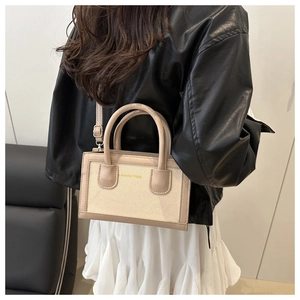Detailed back view of a contrast crossbody square bag with Aunity 1986 text detail