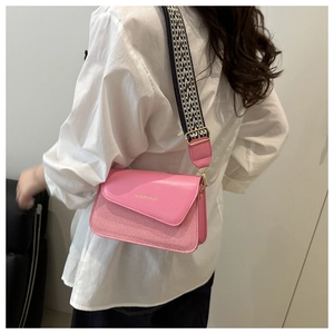 Pink leather and checkered fabric crossbody bag with wide geometric patterned shoulder strap