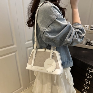 Women's chic beige woven and white leather shoulder bag with circular tag detail