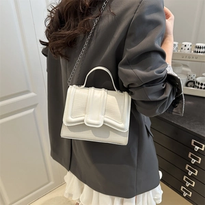 White croc-effect crossbody handbag with elegant top handle and metal chain strap