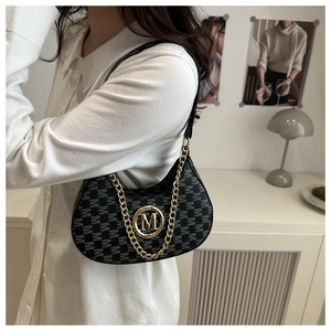 Detailed close-up of a vintage hobo bag featuring M-pattern jacquard and gold chain