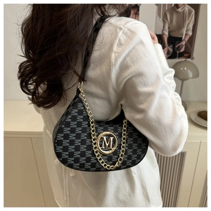 Detail showing vintage grey monogram jacquard fabric and gold chain on the crescent bag