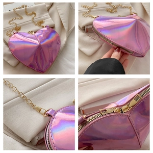 Detailed close-up of pink holographic heart bag with gold chain strap and dual zippers