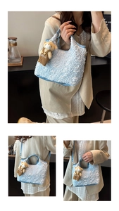 Detail of light blue bubble texture handbag featuring a cute plush bear charm with strap
