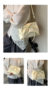Detail of cream pearlescent crossbody bag featuring a large bow and adjustable strap