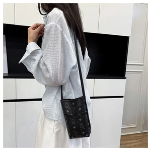Vertical black crossbody phone bag featuring grey bear prints and slim shoulder strap