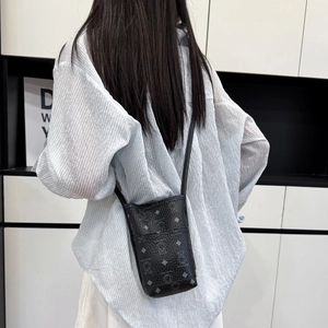Chic black litchi leather crossbody phone bag featuring a trendy silver bear print