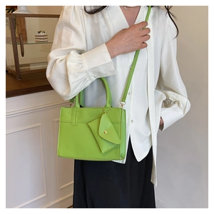 Detailed lime green crossbody bag featuring a matching small envelope coin pouch detail
