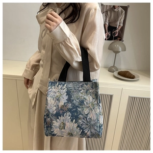 Detailed retro floral jacquard handbag being carried by a model in a cozy setting