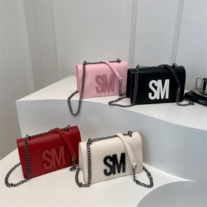Minimalist square chain bags in four colors with 3D SM letter logos on display