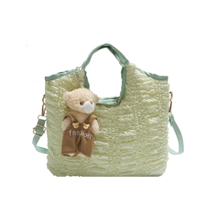 Mint green pleated bucket bag with bear pendant and adjustable crossbody strap