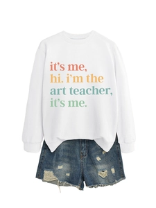 Detail of white crewneck sweatshirt with 'it's me hi i'm the art teacher' text print