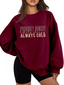 Detail of burgundy oversized sweatshirt featuring Probably Hungry slogan print and ribbing