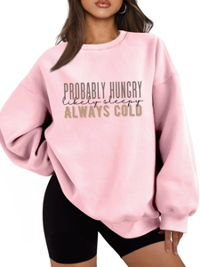 Detail of the PROBABLY HUNGRY text print on a light pink fleece crewneck sweatshirt