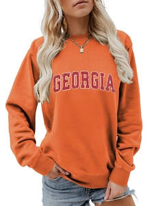 Detail of orange Georgia sweatshirt showing ribbed crew neck and athletic letter print
