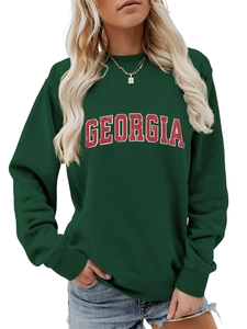 Close-up of the dark green sweatshirt showing GEORGIA lettering and rib-knit cuffs