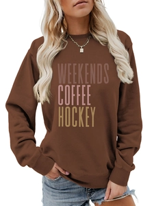 Detail of coffee-colored sweatshirt with 'Weekends Coffee Hockey' text and crew neck
