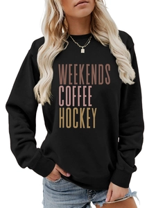 Detailed view of weekends coffee hockey text print on black crewneck sweatshirt fabric