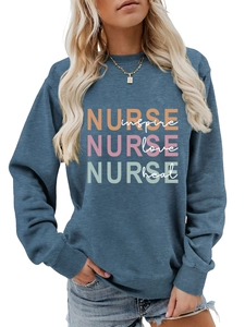 Detail of navy crewneck sweatshirt showing Nurse inspire love heal colorful print design