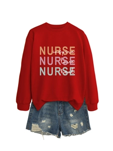 Detail of red nurse sweatshirt with 'inspire love heal' print and denim shorts