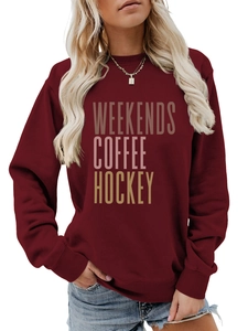 Detail of burgundy crewneck sweatshirt featuring Weekends Coffee Hockey gradient print