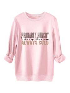 Detail of rolled cuffs and slogan print on a thick pink warm fleece sweatshirt