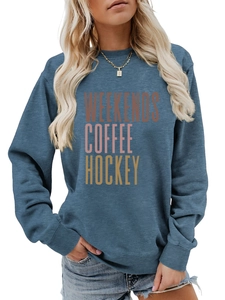Detail of ribbed cuffs and WEEKENDS COFFEE lettering on the blue-grey sweatshirt