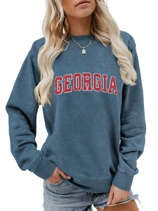 Detailed close-up of ribbed crewneck and Georgia lettering on blue cotton sweatshirt
