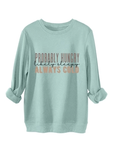 Detail of mint green sweatshirt featuring Probaly Hungry likely sleepy printed slogans