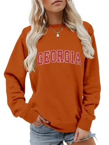 Detail of Georgia letter print on an orange loose long-sleeved sweatshirt for women