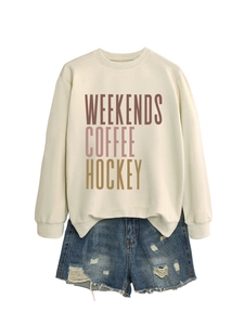 Detailed flat lay of beige sweatshirt with WEEKENDS COFFEE HOCKEY print and denim shorts