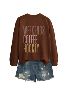 Detail view of the Weekends Coffee Hockey art print on a brown sweatshirt fabric
