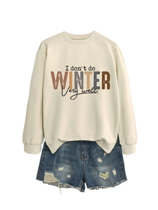 Detail of colorful 'I don't do winter very well' graphic on cream crewneck sweatshirt