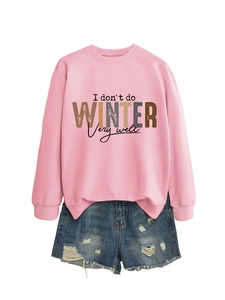 Flat lay of pink sweatshirt with 'I don't do winter' slogan and ripped denim shorts