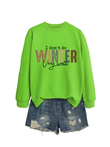 Flat lay of neon green sweatshirt with 'I don't do winter' text and ripped denim shorts