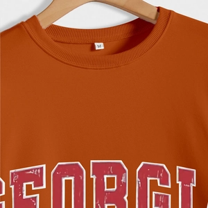 Orange crewneck sweatshirt with vintage Georgia letter print and soft fabric texture