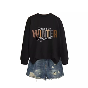 Women's black crewneck sweatshirt with 'I don't do winter' text and distressed denim shorts