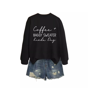 Black crewneck long sleeve coffee baggy sweater with distressed denim shorts on white background