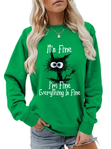 Close-up of ribbed crewneck and humorous cat graphic on a green sweatshirt