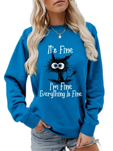 Detail of royal blue crewneck sweatshirt with 'It's Fine' cat print and soft cotton texture