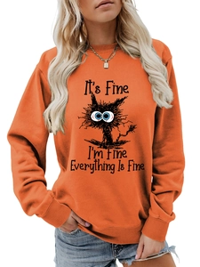Detail of funny cat print and Everything Is Fine text on orange crewneck sweatshirt