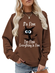 Detail of funny cat graphic and text on a brown long sleeve crewneck sweatshirt