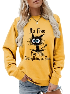 Detail of the ribbed cuffs and cartoon cat print on this ginger yellow crewneck sweatshirt
